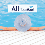 pessoa deitada de costas com chapéu de praia em uma piscina com logo All TudoAzul