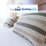 Cama de quarto de hotel com logo tudoazul booking