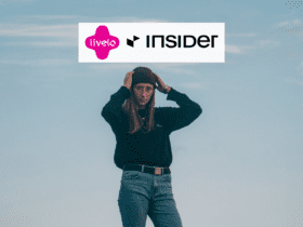 mulher loira com camisa e gorro preto de calça, com logo Livelo e Insider