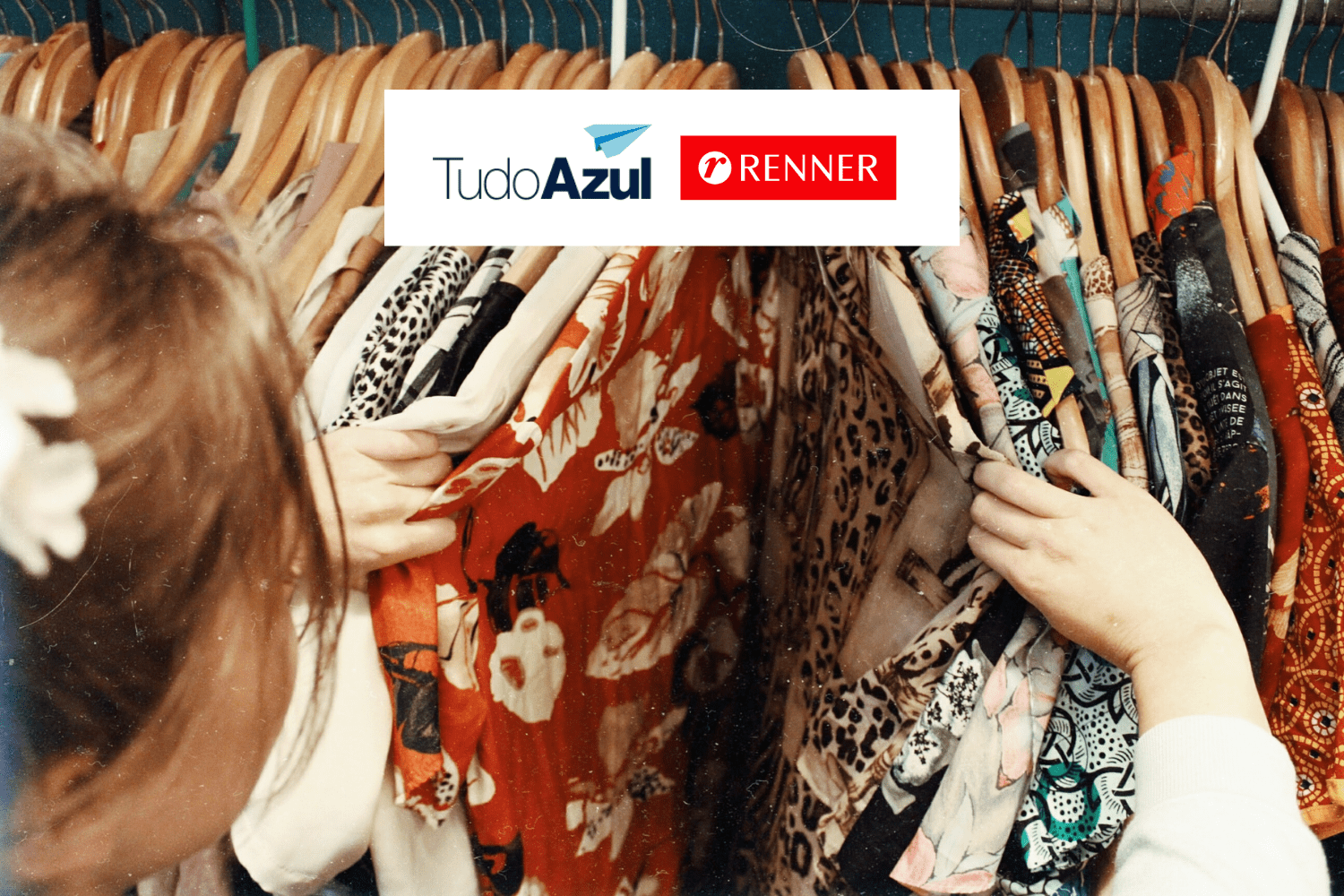 pessoa escolhendo roupa em arara com logo TudoAzul e Renner 14 pontos TudoAzul