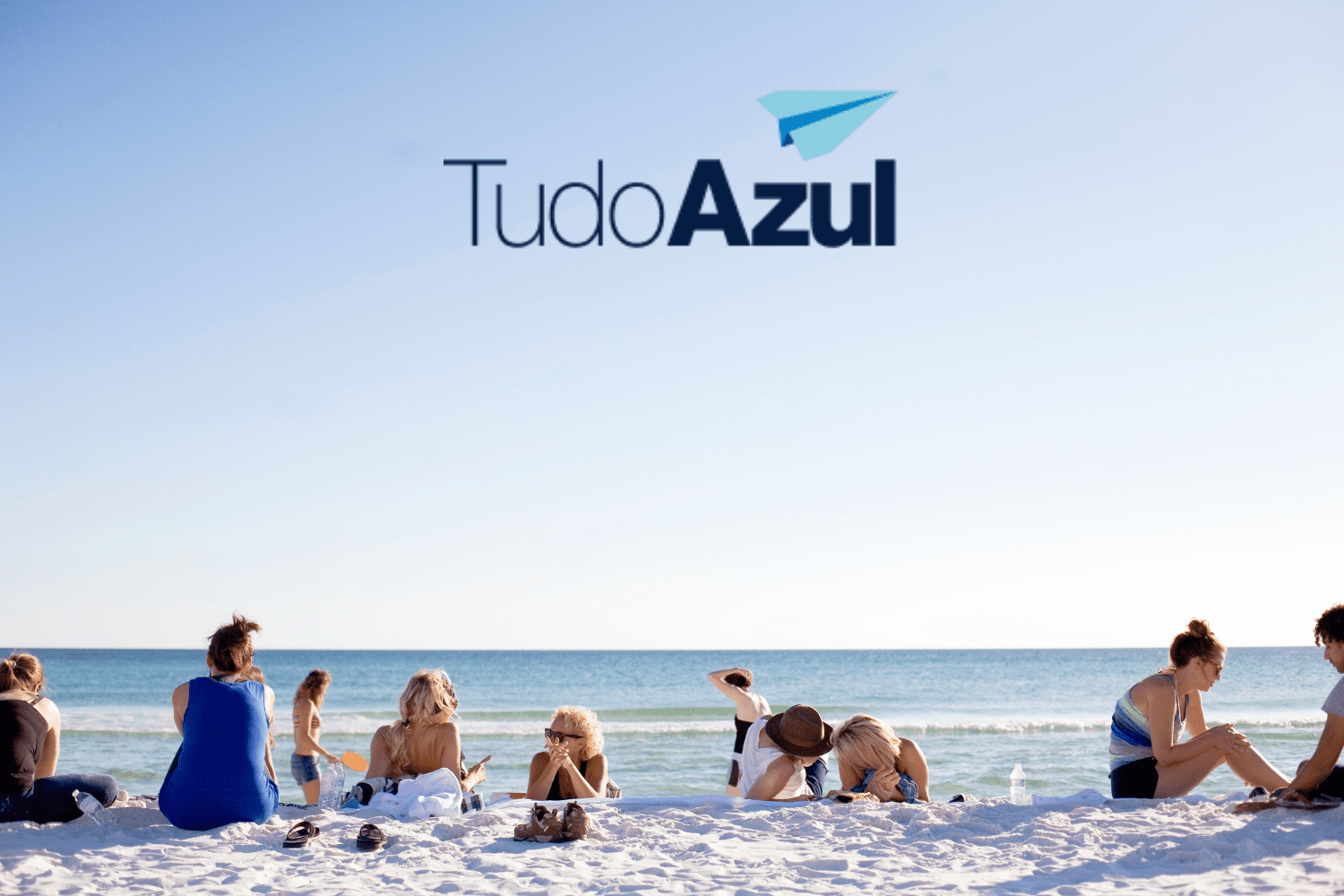pessoas na praia com logo TudoAzul bônus TudoAzul