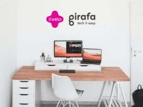 mesa com computadores com logo Livelo e Girafa 10 pontos Livelo