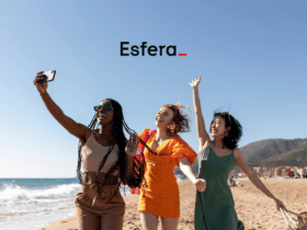 Pontos Esfera 50% OFF. Três mulheres sorrindo e tirando uma selfie em uma praia ensolarada, com o logotipo da Esfera no topo da imagem.