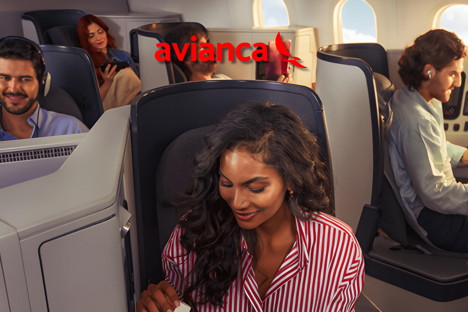 Passageiros aproveitando o conforto da classe executiva Insigna da Avianca, com cabines modernas, espaçosas e serviço premium durante o voo.